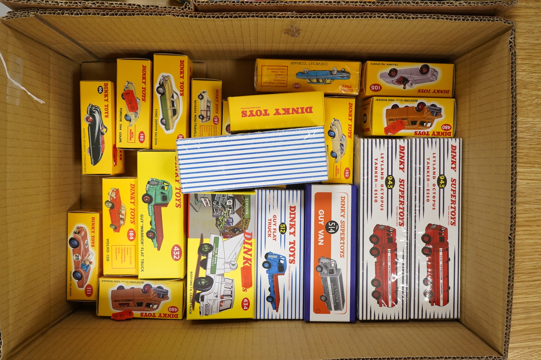 Twenty-two boxed Atlas Dinky Toys, including cars and commercial vehicles, Leyland tankers, sports cars, etc.